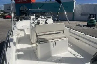 Slide: The Image of 2024 Boston Whaler 190 Montauk boat interior with steering console and seating. - 6
