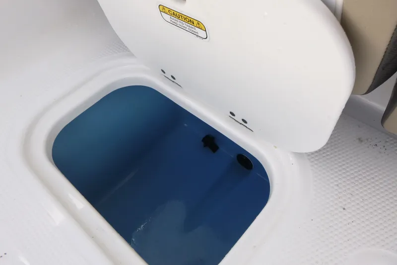Slide: The Image of Open storage compartment on 2024 Tahoe 185 S boat, featuring a blue interior. - 11