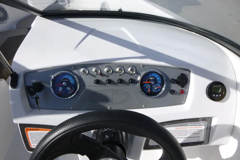 Slide: The Image of 2024 Tahoe 185 S boat dashboard with gauges and controls, featuring a sleek design. - 13