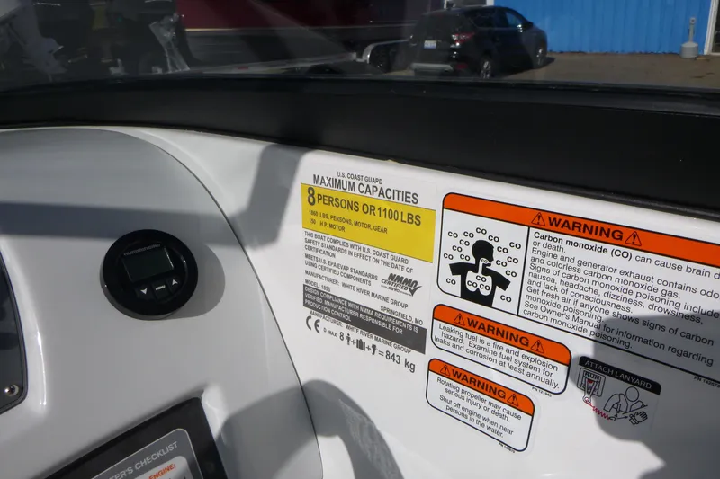 Slide: The Image of Dashboard of 2024 Tahoe 185 S boat with capacity and safety warnings. - 14