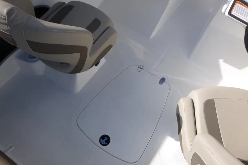 Slide: The Image of 2024 Tahoe 185 S boat interior with beige seating and storage compartment. - 16