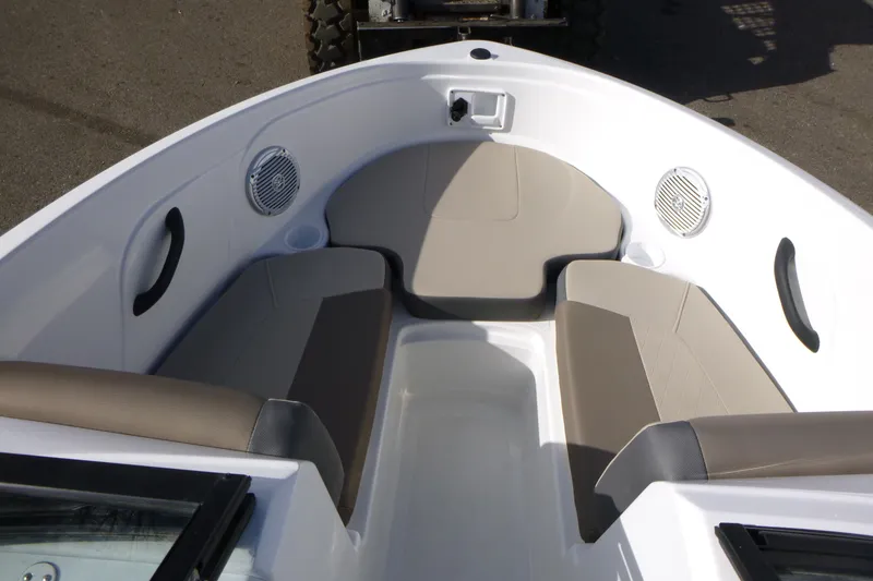 Slide: The Image of 2024 Tahoe 185 S boat interior with beige seating and built-in speakers. - 18