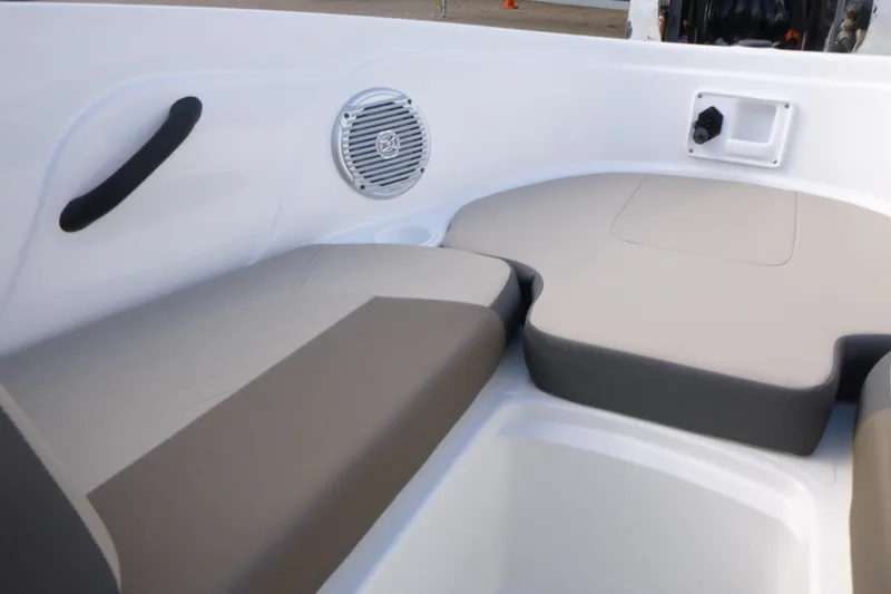 Slide: The Image of 2024 Tahoe 185 S boat interior with cushioned seating and speaker. - 19