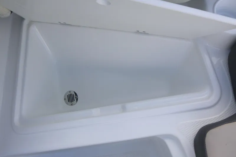 Slide: The Image of 2024 Tahoe 185 S boat storage compartment with drain, open lid view. - 20