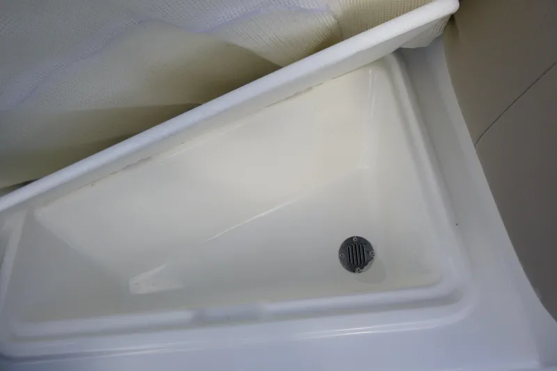 Slide: The Image of 2024 Tahoe 185 S boat interior with white triangular sink and drain. - 23