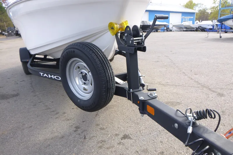 Slide: The Image of 2024 Tahoe 185 S boat on trailer, close-up of wheel and hitch. - 26