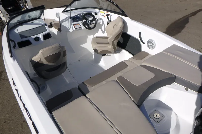 Slide: The Image of 2024 Tahoe 185 S boat interior with beige seating and modern dashboard. - 6