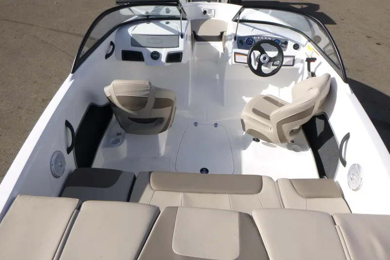 Slide: The Image of 2024 Tahoe 185 S boat interior with beige seating and modern dashboard design. - 7