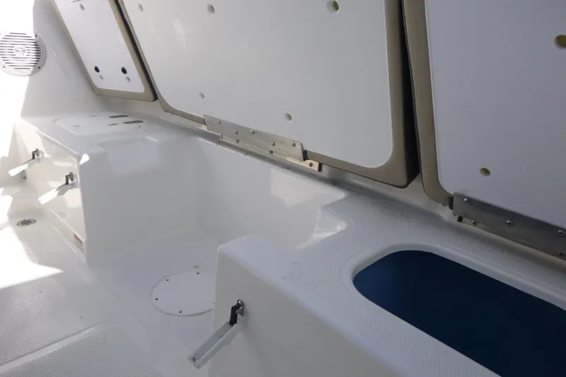 Slide: The Image of 2024 Tahoe 185 S boat interior storage compartments and seating area. - 9