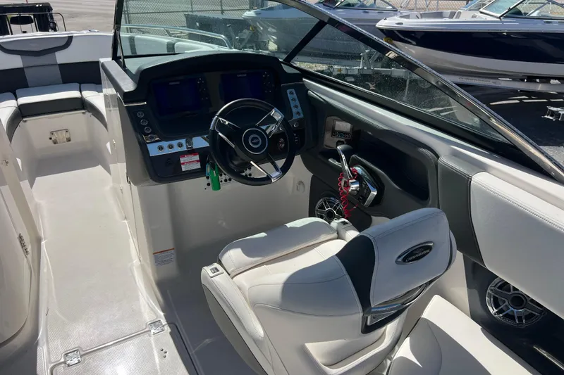 Slide: The Image of 2023 Chaparral 270 OSX boat interior with steering wheel and control panel. - 13