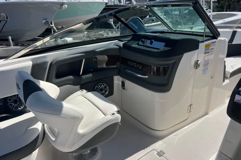 Slide: The Image of 2023 Chaparral 270 OSX boat interior with helm and seating area. - 16