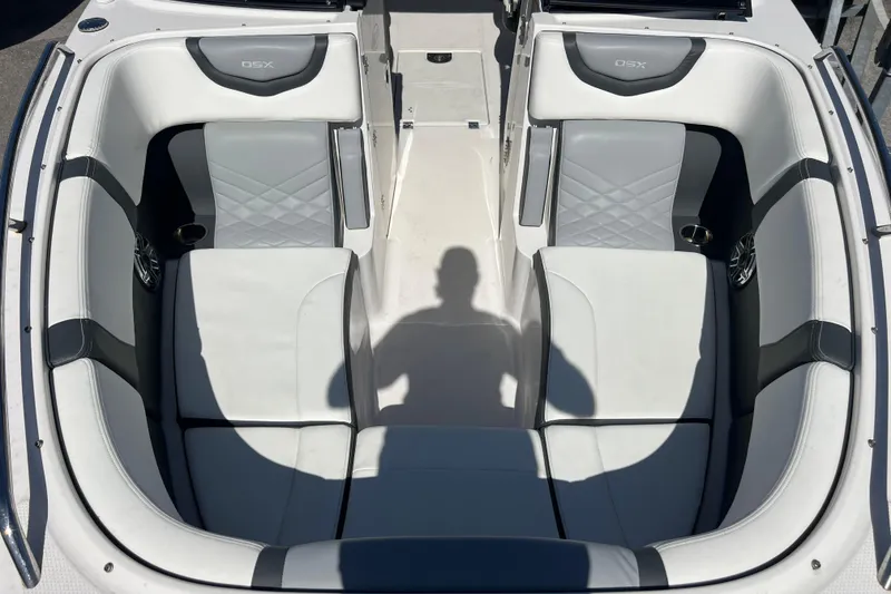 Slide: The Image of 2023 Chaparral 270 OSX boat interior with white and gray seating. - 19