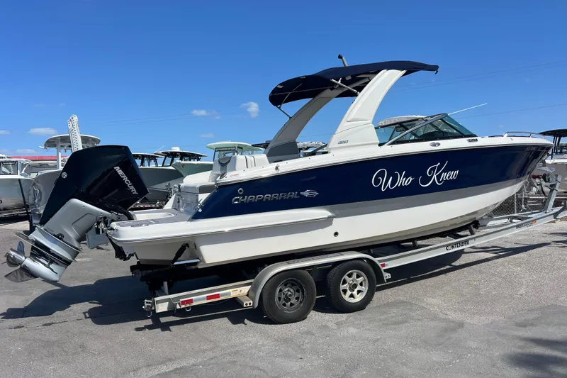 Slide: The Image of 2023 Chaparral 270 OSX boat on trailer, featuring sleek design and "Who Knew" text. - 2