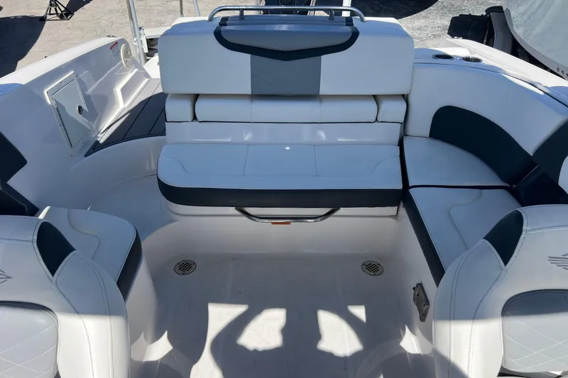 Slide: The Image of 2023 Chaparral 270 OSX boat interior with white and gray seating arrangement. - 23