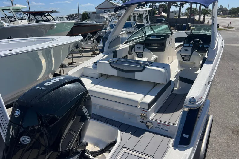 Slide: The Image of 2023 Chaparral 270 OSX boat with spacious seating and powerful outboard motor. - 5