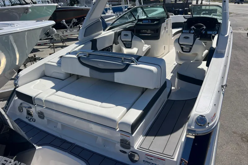 Slide: The Image of 2023 Chaparral 270 OSX boat interior with luxurious seating and modern dashboard. - 6