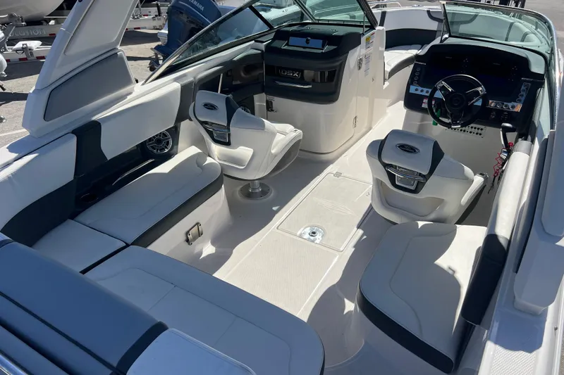 Slide: The Image of 2023 Chaparral 270 OSX boat interior with modern seating and dashboard design. - 9