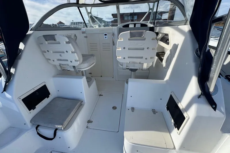 Slide: The Image of 2004 Boston Whaler 255 Conquest boat interior with helm and seating. - 12