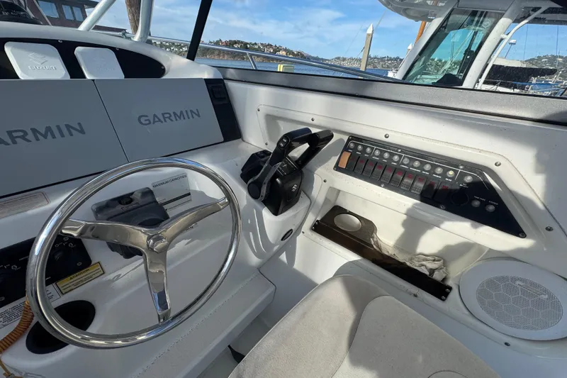 Slide: The Image of 2004 Boston Whaler 255 Conquest helm with Garmin navigation and control panel. - 13