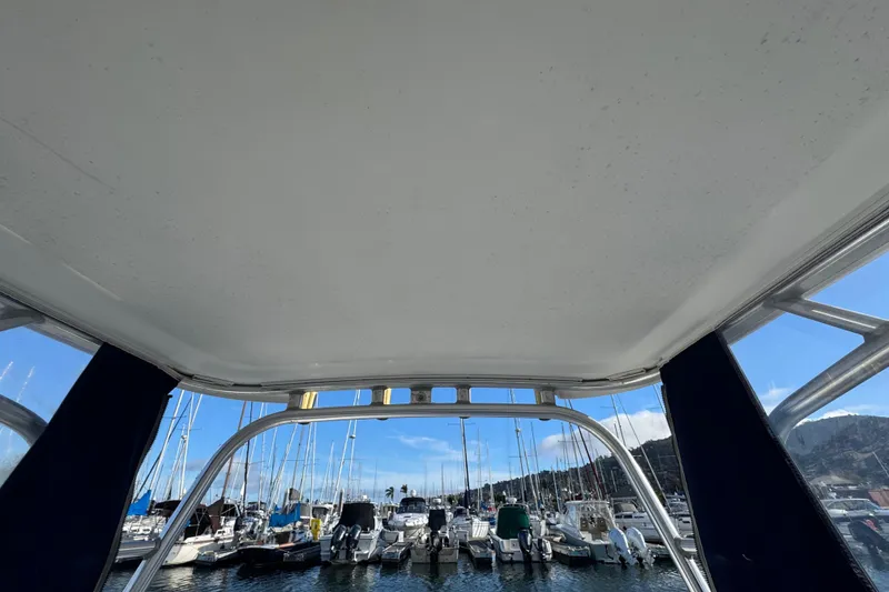 Slide: The Image of View from 2004 Boston Whaler 255 Conquest, overlooking marina with boats and clear sky. - 16