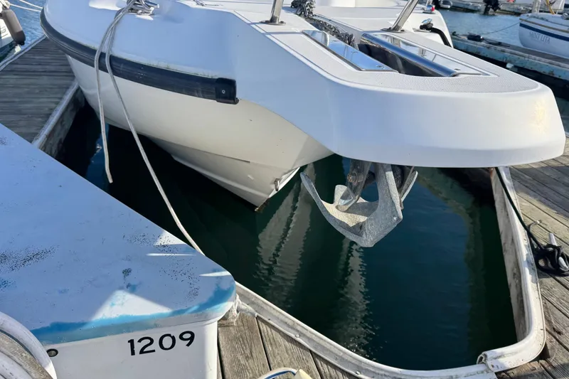 Slide: The Image of Boston Whaler 255 Conquest 2004 docked, showing anchor and bow details. - 19