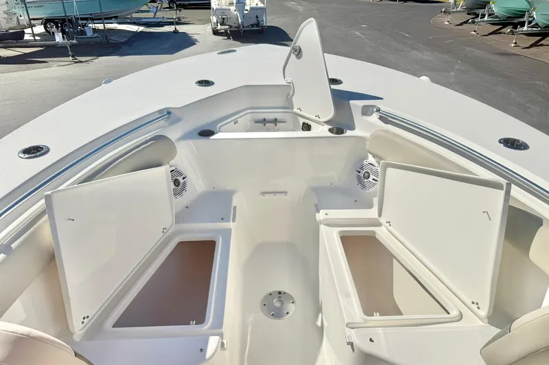 Slide: The Image of 2026 Key West 244 Center Console boat interior with beige seating and speakers. - 17