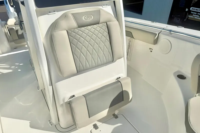 Slide: The Image of 2026 Key West 244 Center Console boat interior with cushioned seating and storage compartments. - 19