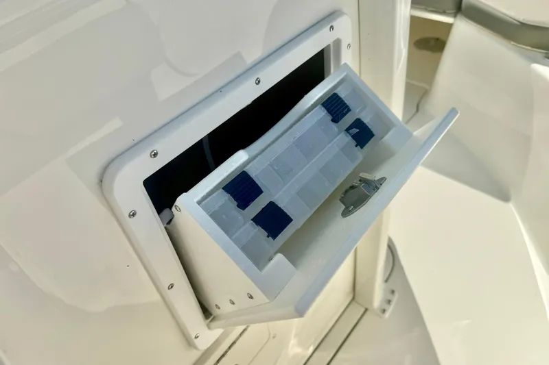 Slide: The Image of 2026 Key West 244 Center Console boat interior with open storage compartments. - 22