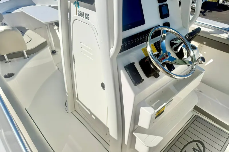 Slide: The Image of 2026 Key West 244 Center Console boat interior storage compartment with open hatch. - 23