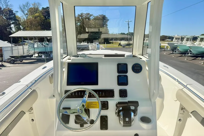 Slide: The Image of 2026 Key West 244 Center Console boat interior with cushioned seating and modern design. - 25