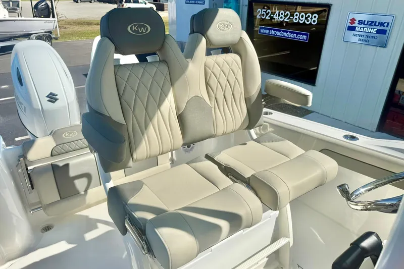 Slide: The Image of Storage compartment on 2026 Key West 244 Center Console boat, featuring organized tackle boxes. - 28