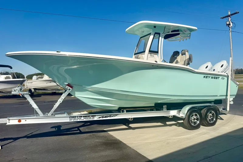 Slide: The Image of 2026 Key West 244 Center Console boat on trailer, displayed outdoors. - 5