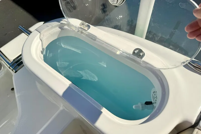 Slide: The Image of Livewell on 2026 Key West 244 Center Console boat, open lid showing water inside. - 52