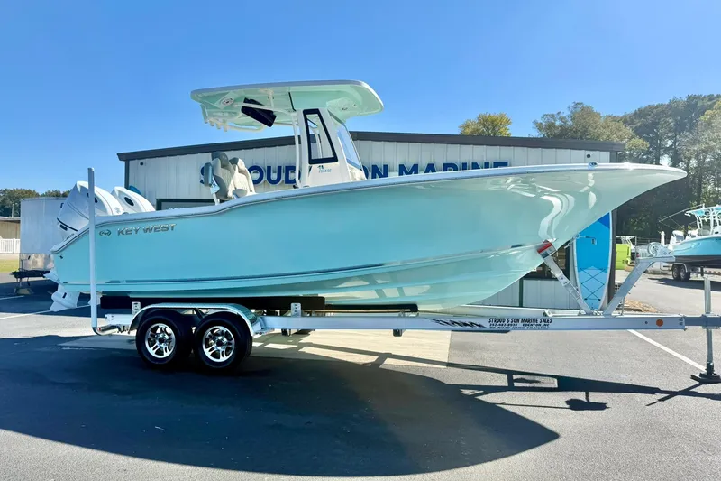 Slide: The Image of 2026 Key West 244 Center Console boat on trailer, displayed outdoors. - 7