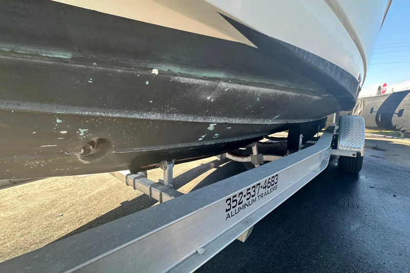 Slide: The Image of 2009 Scarab Sport 30 boat on aluminum trailer, underside view. - 10