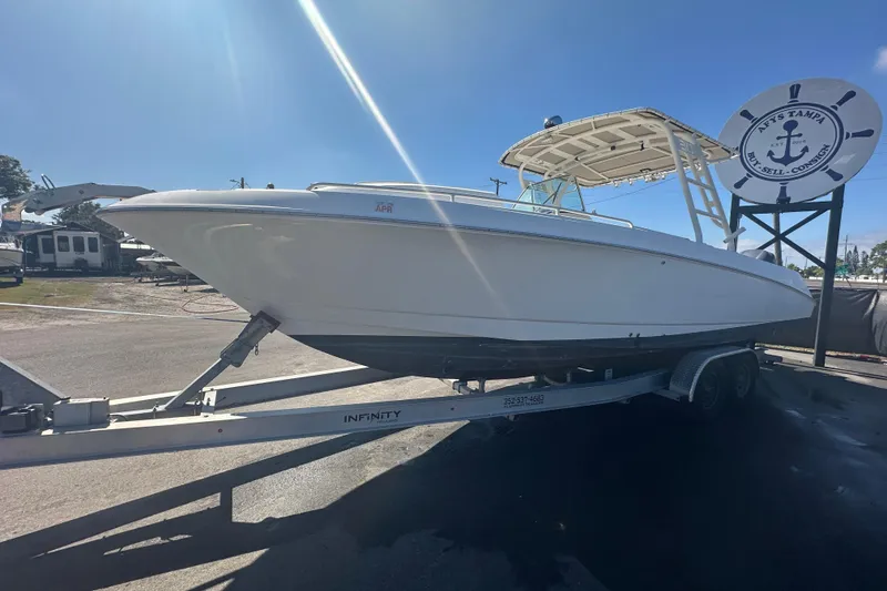 Slide: The Image of 2009 Scarab Sport 30 boat on trailer under clear blue sky. - 11