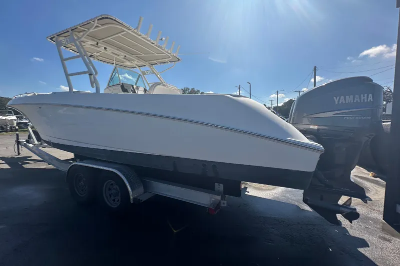 Slide: The Image of 2009 Scarab Sport 30 boat on trailer with Yamaha outboard motor, sunny day. - 12