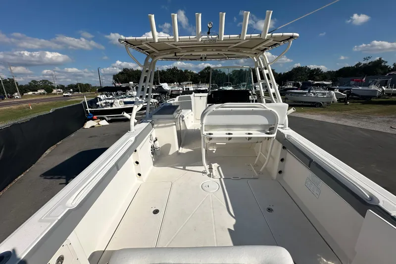 Slide: The Image of 2009 Scarab Sport 30 boat interior with seating and helm, displayed outdoors. - 19