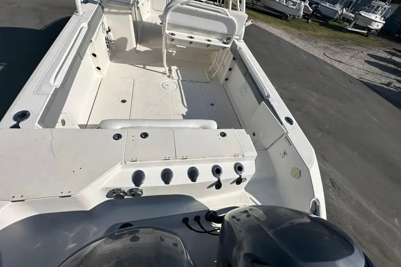 Slide: The Image of 2009 Scarab Sport 30 boat interior with seating and controls, docked outdoors. - 20