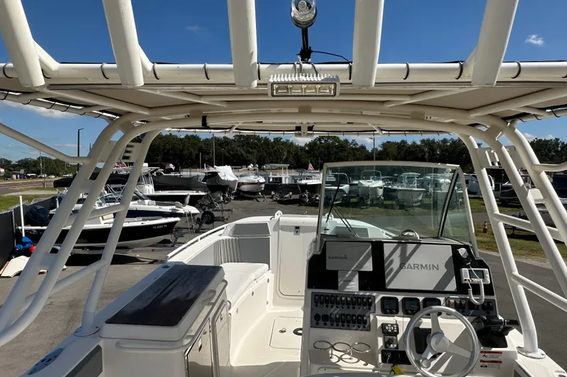 Slide: The Image of 2009 Scarab Sport 30 boat with Garmin navigation, docked among other boats. - 25