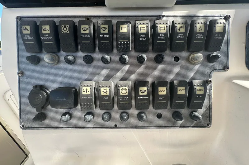 Slide: The Image of Control panel of a 2009 Scarab Sport 30 boat with labeled switches and buttons. - 30