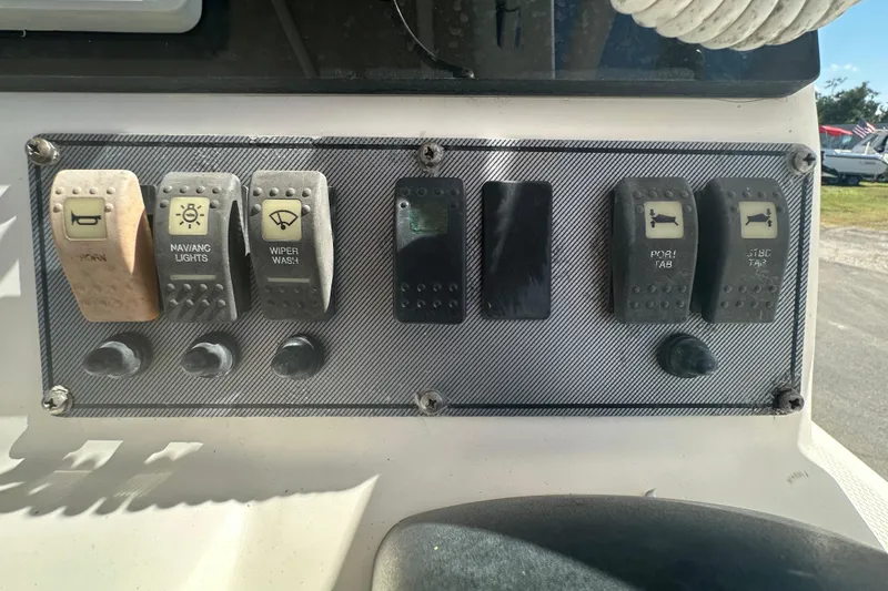 Slide: The Image of Control panel of a 2009 Scarab Sport 30 boat with labeled switches. - 36