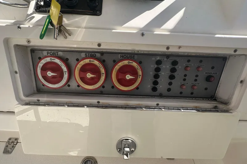 Slide: The Image of Control panel of a 2009 Scarab Sport 30 boat with switches and keys. - 37