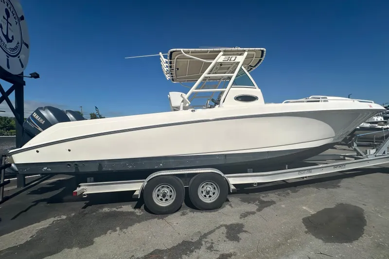 Slide: The Image of 2009 Scarab Sport 30 boat on trailer, side view under clear blue sky. - 4