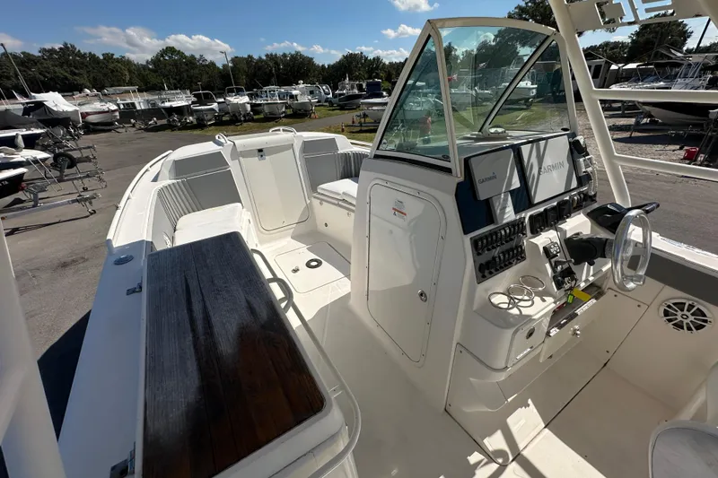 Slide: The Image of 2009 Scarab Sport 30 boat interior with control panel and seating, docked at marina. - 40