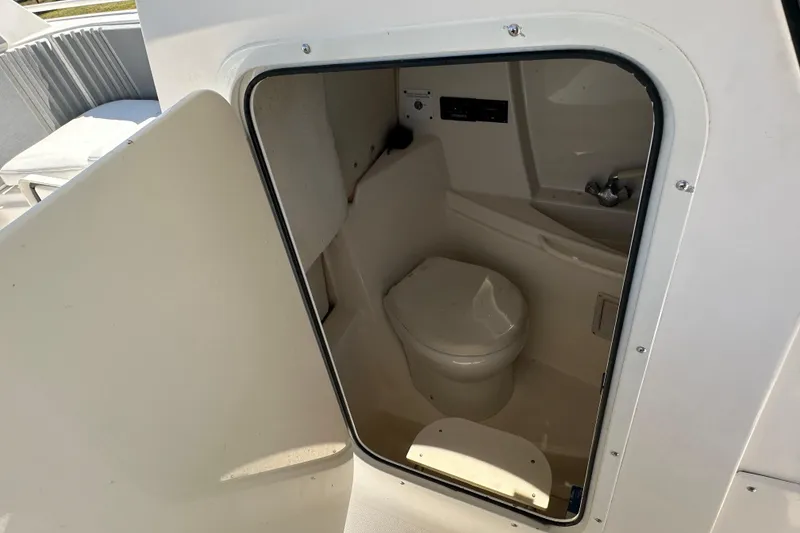 Slide: The Image of 2009 Scarab Sport 30 boat interior with compact bathroom and toilet. - 41