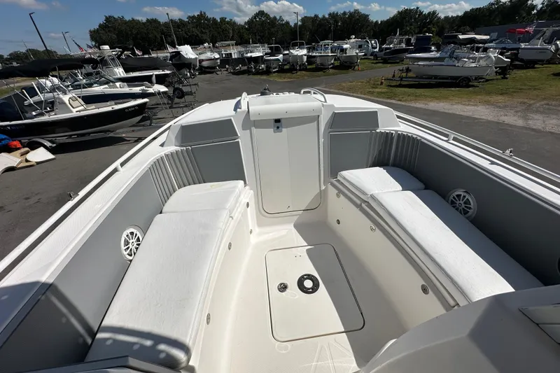 Slide: The Image of 2009 Scarab Sport 30 boat interior with white seating, docked among other boats. - 44