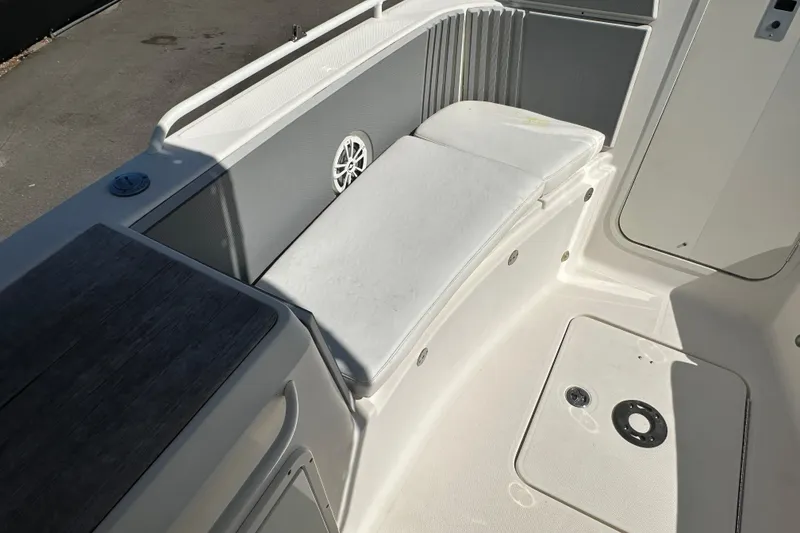 Slide: The Image of 2009 Scarab Sport 30 boat interior with white seating and speaker. - 47