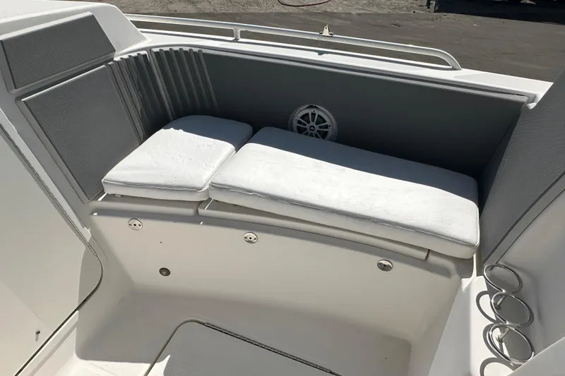 Slide: The Image of 2009 Scarab Sport 30 boat seating area with white cushions and speaker. - 48