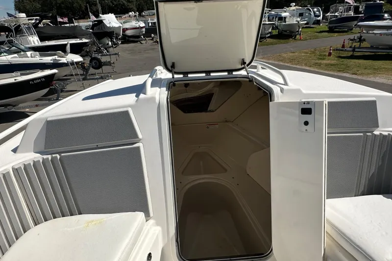 Slide: The Image of 2009 Scarab Sport 30 boat interior with open hatch, surrounded by other boats. - 49